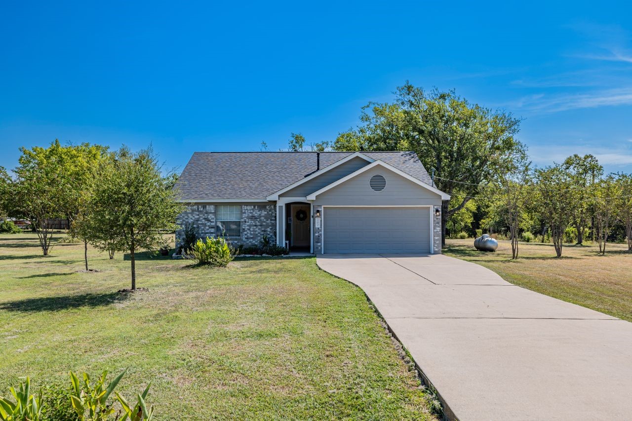 200 Richard Road Georgetown, TX 78626 - Photo 1 of 1 This home features a spacious lot, a paved driveway, and a well-maintained exterior.