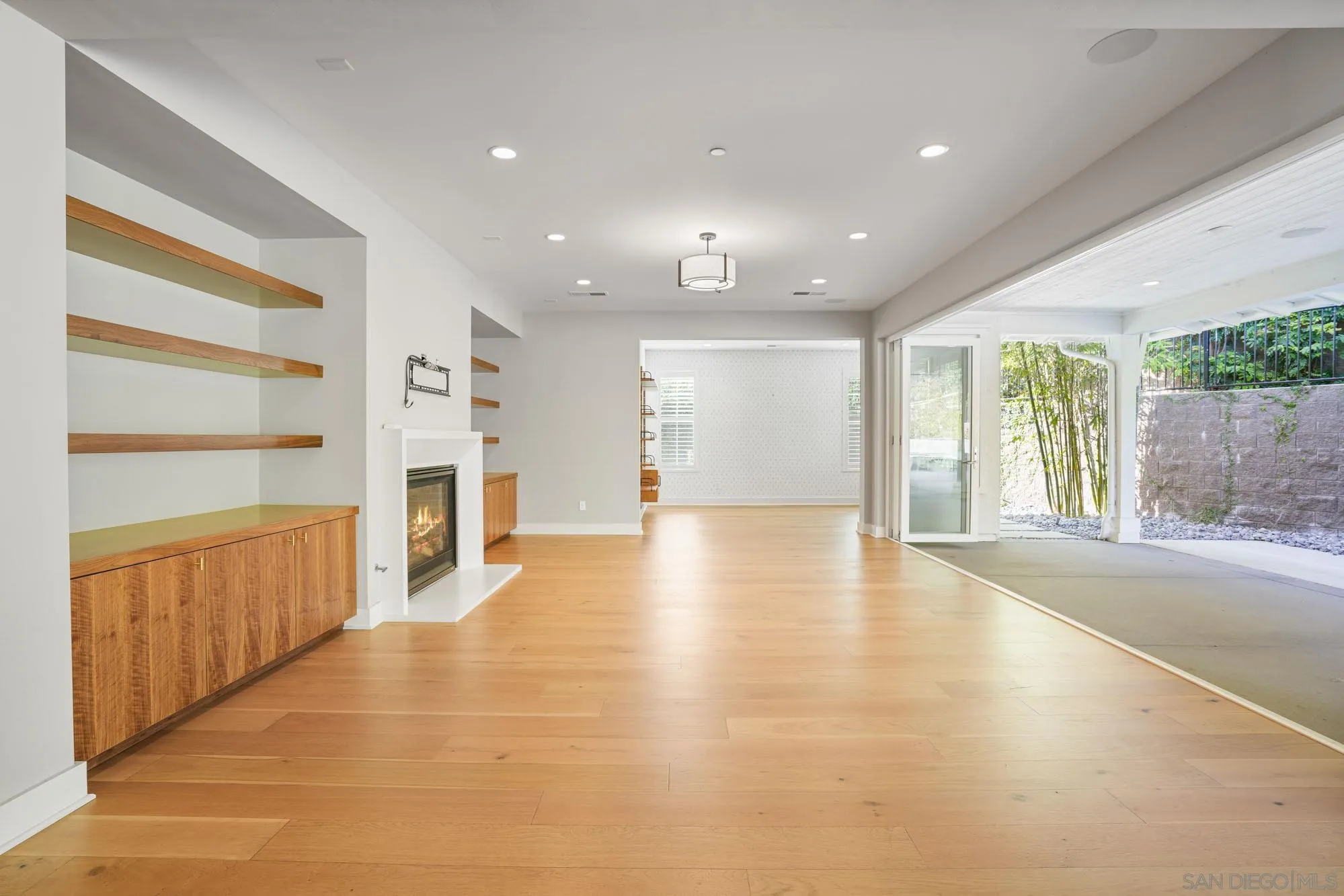 833 Channel Island Drive Encinitas, CA 92024 - Photo 13 of 38 a view of empty room with wooden floor and fireplace