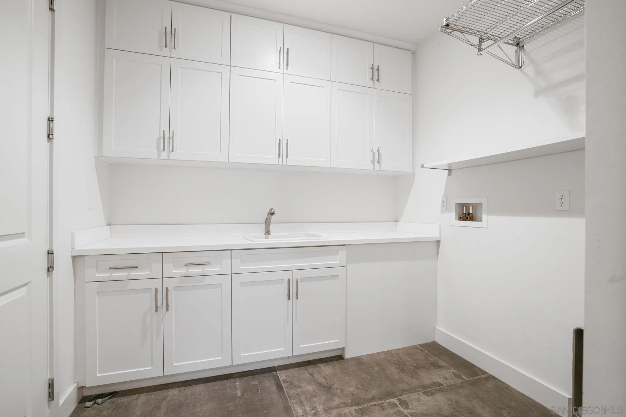 833 Channel Island Drive Encinitas, CA 92024 - Photo 17 of 38 a kitchen with white cabinets and sink