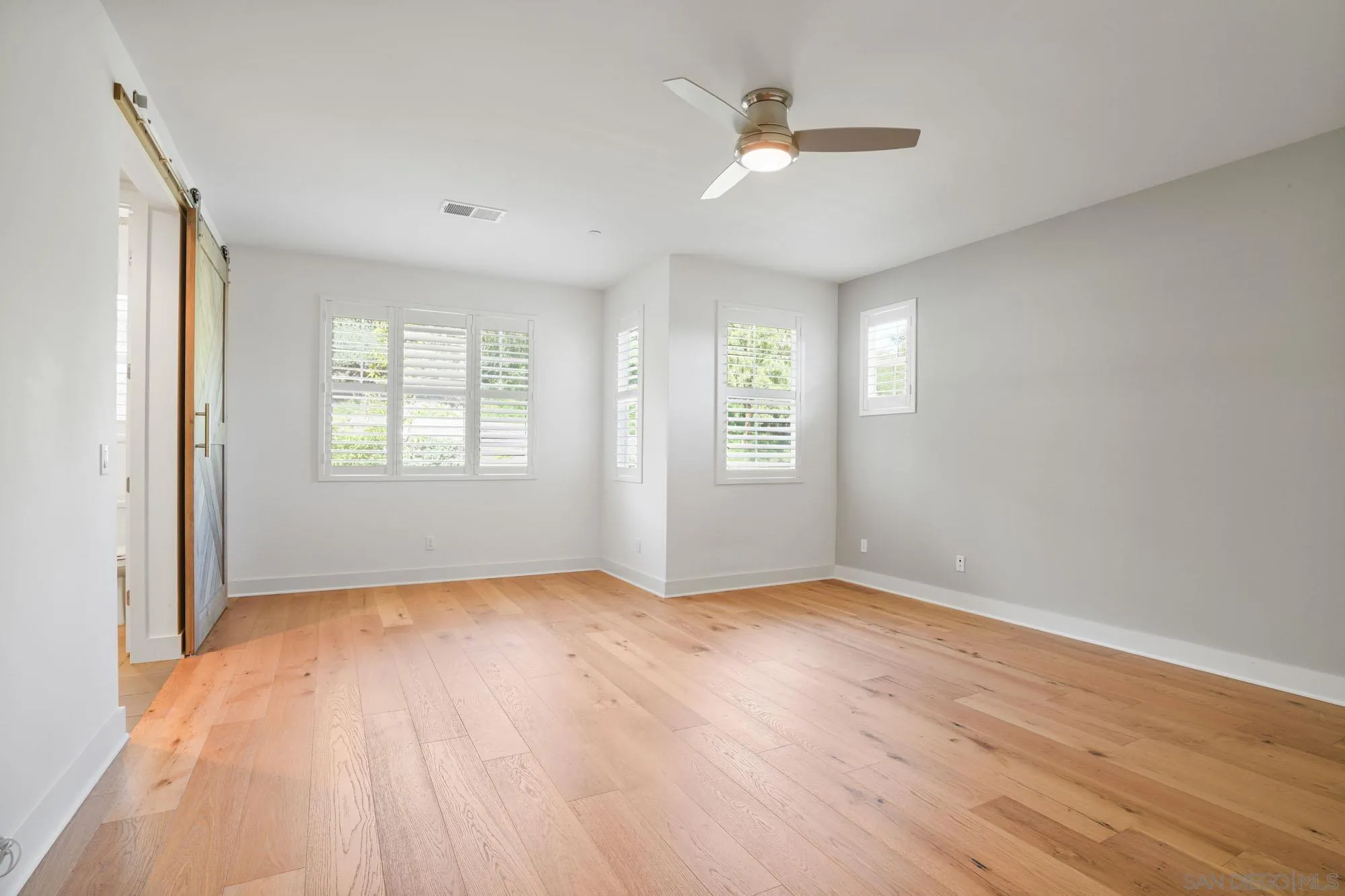 833 Channel Island Drive Encinitas, CA 92024 - Photo 19 of 38 a view of an empty room with a window and wooden floor