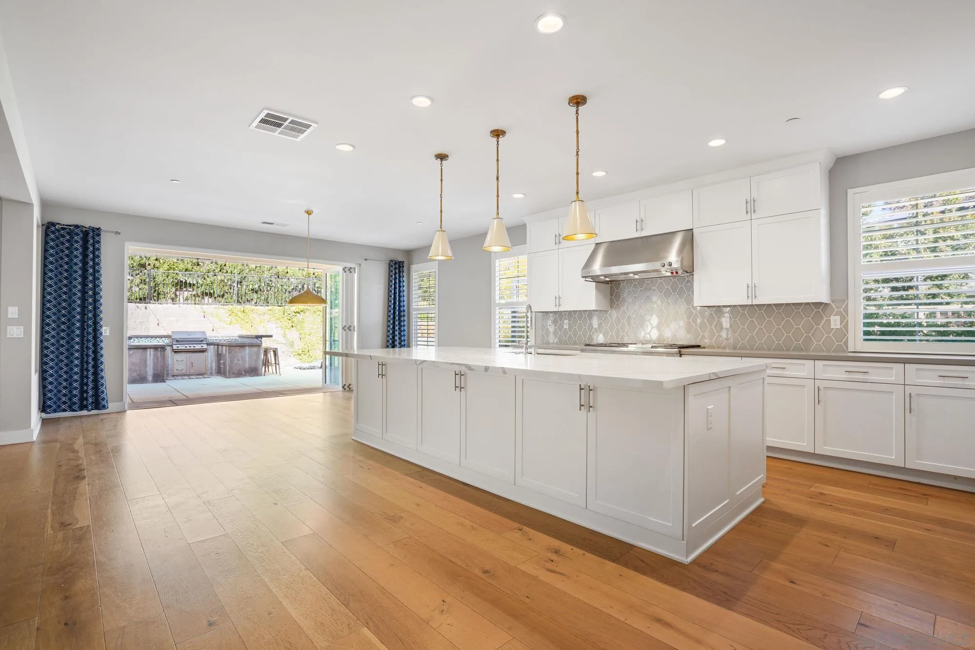 833 Channel Island Drive Encinitas, CA 92024 - Photo 7 of 38 a large kitchen with stainless steel appliances granite countertop a large window a sink and a refrigerator