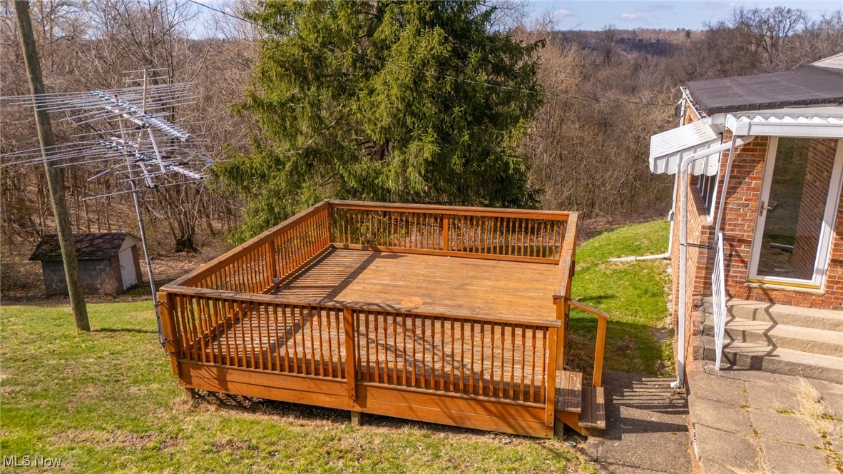 56260 Davis Road Bellaire, OH 43906 - Photo 5 of 44 Deck with a lawn and a view of trees