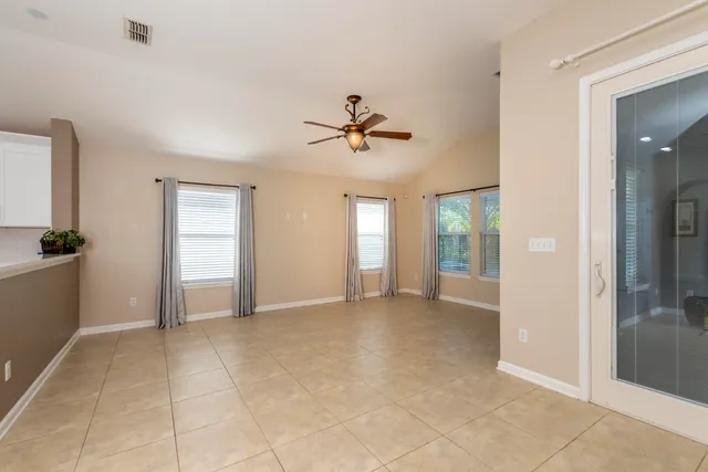 a view of kitchen with stainless steel appliances granite countertop a refrigerator and a sink