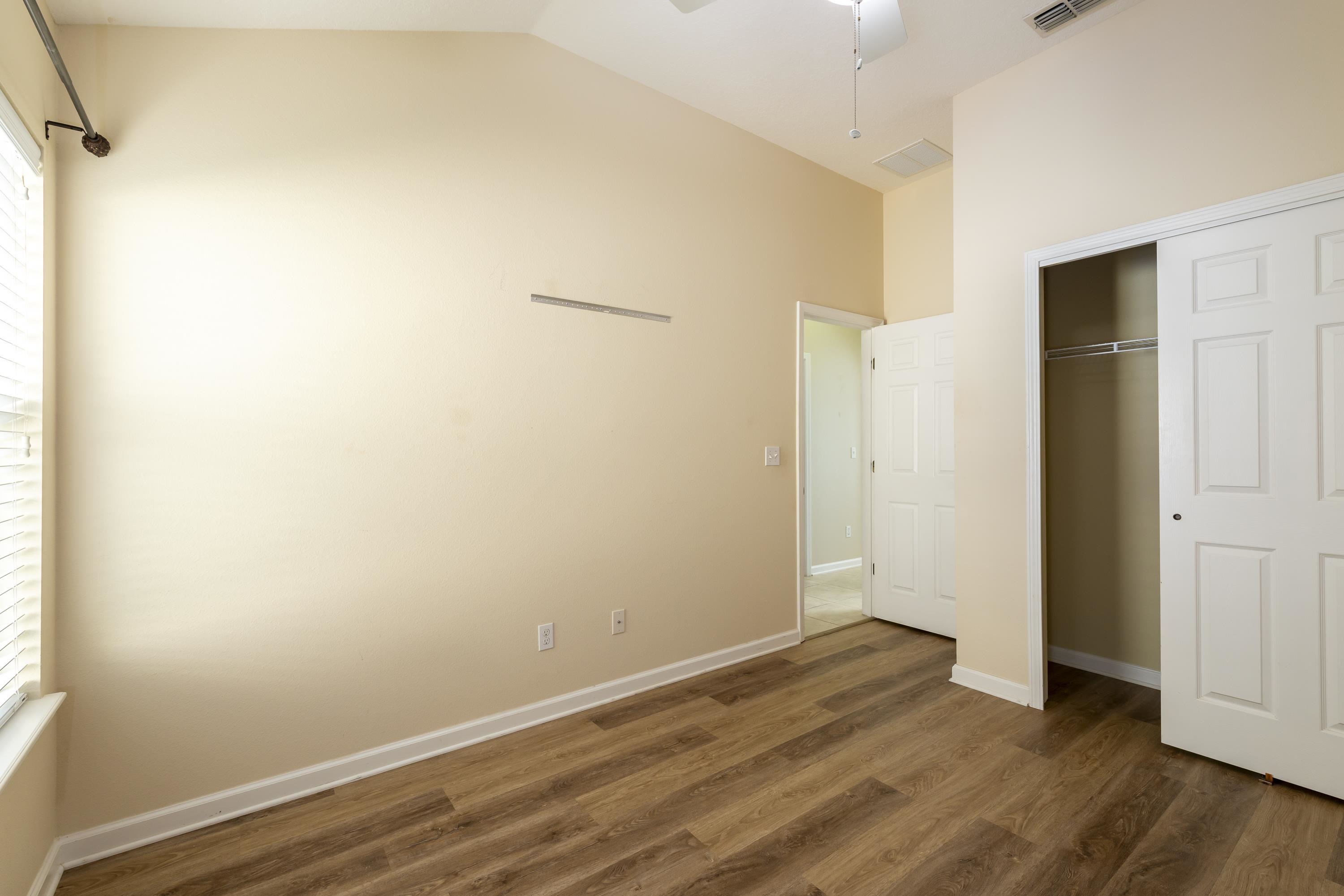 73 Durango Drive St. Augustine, FL 32086 - Photo 17 of 38 a view of an empty room with wooden floor and a window