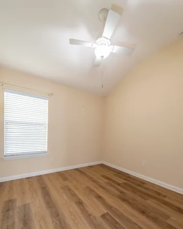 a view of an empty room and wooden floor