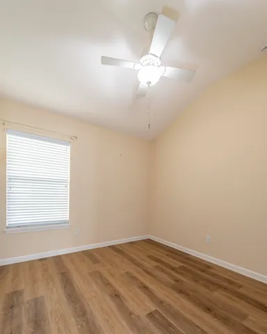 a view of an empty room and wooden floor