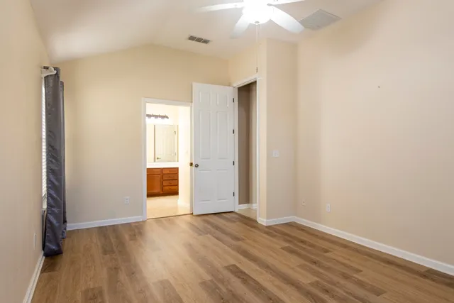 a large spacious bathroom with a granite countertop tub sitting next to a large window