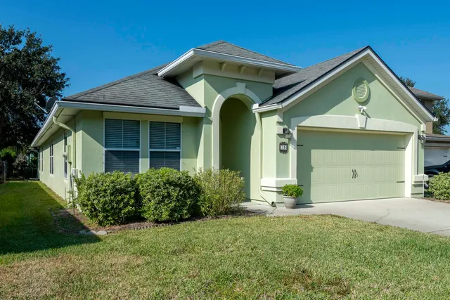 a front view of a house with lots of green space