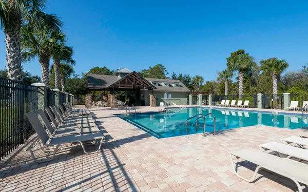 a view of a patio with table and chairs potted plants with wooden floor and fence