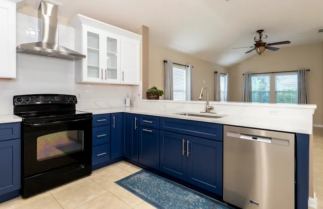 a view of a livingroom with a ceiling fan and window