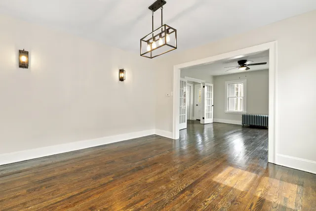 a view of a room with wooden floor and windows
