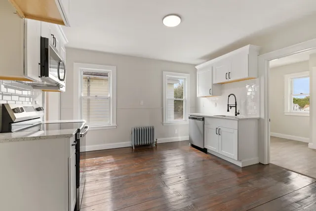 a room with a chair and a stove top oven