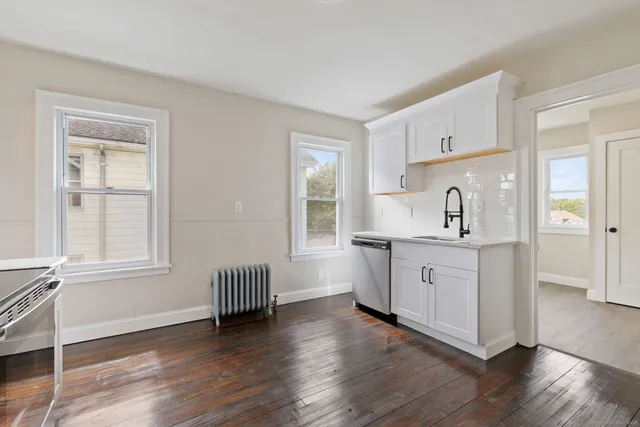 a kitchen with wooden floors and sink