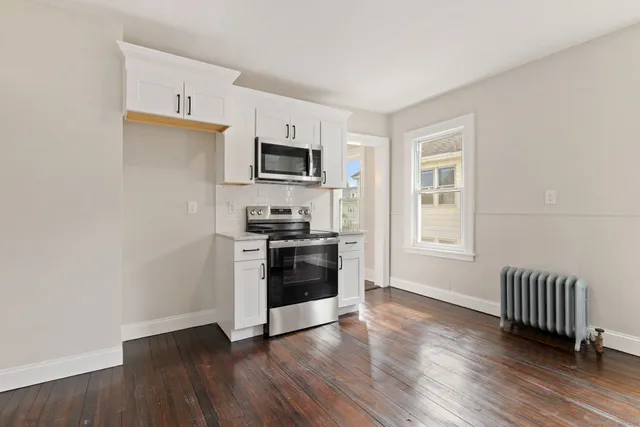 a kitchen with wooden floors and appliances