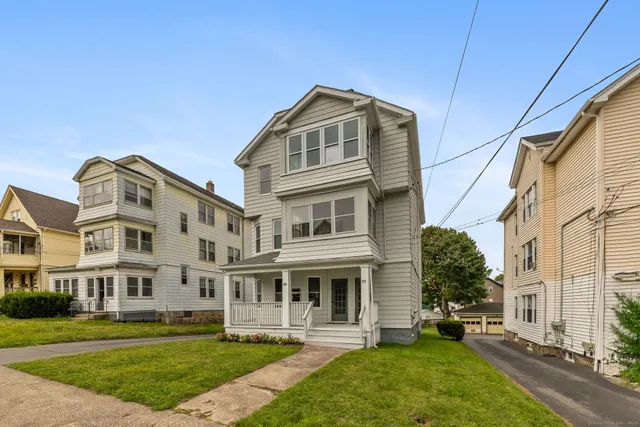 a front view of a building with a yard