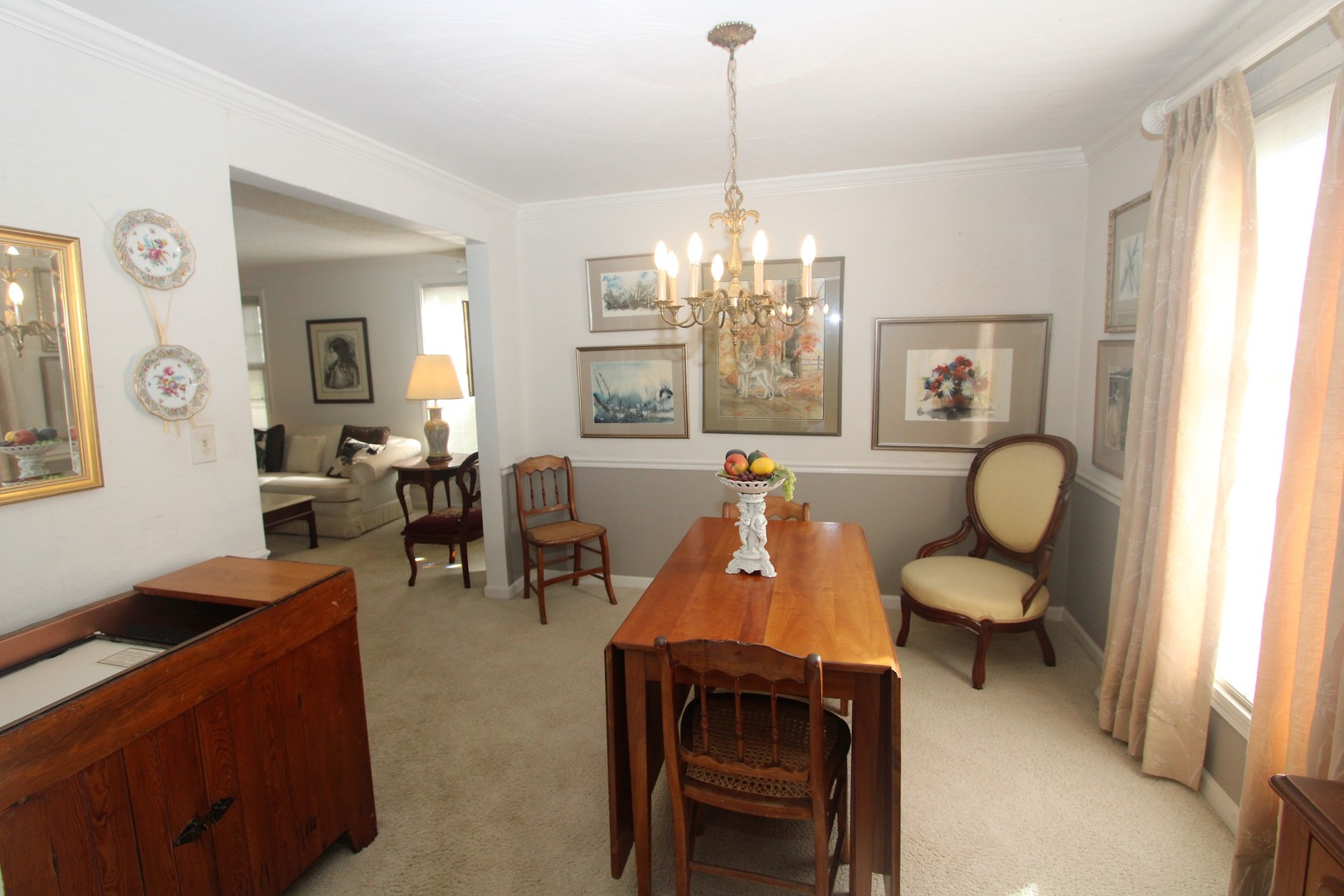1613 Jones Street Joliet, IL 60435 - Photo 7 of 29 a living room with furniture and a chandelier