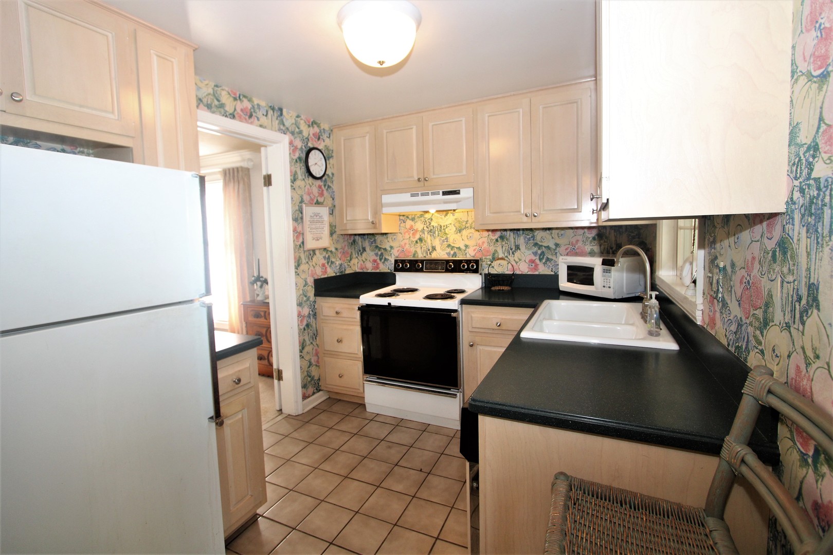 1613 Jones Street Joliet, IL 60435 - Photo 10 of 29 a kitchen with a refrigerator a sink and a stove