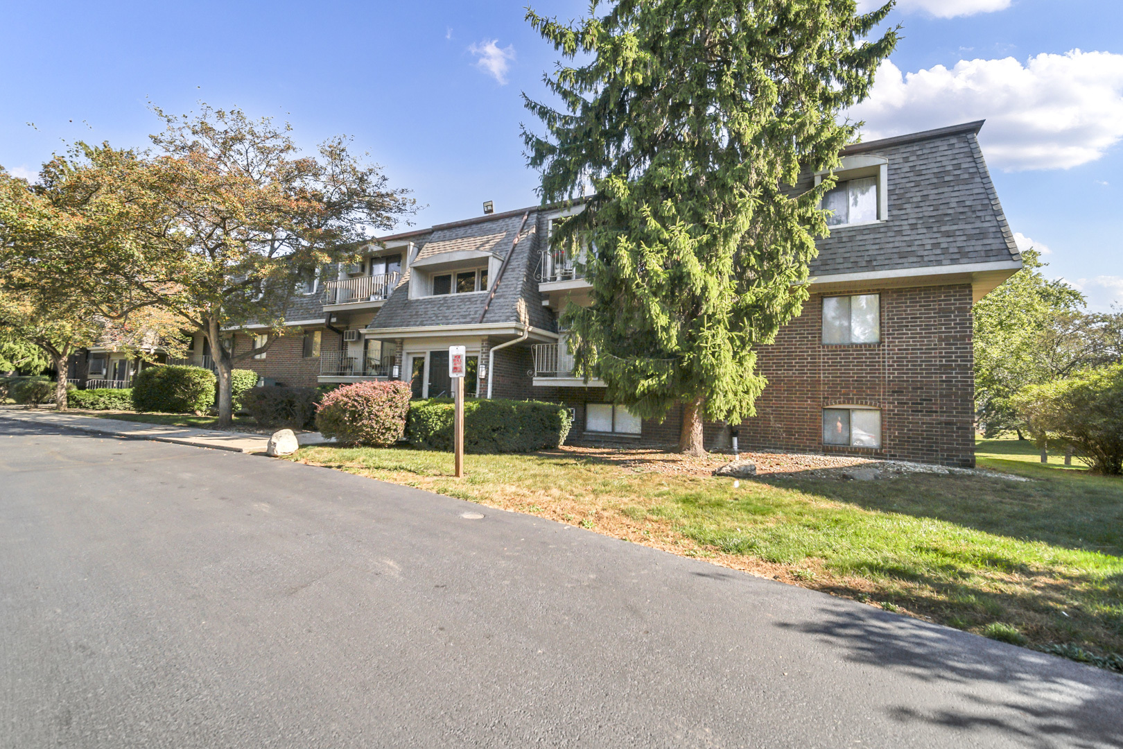 138 East Bailey Road, Unit M Naperville, IL 60565 - Photo 3 of 13 a front view of a house with a yard and garage