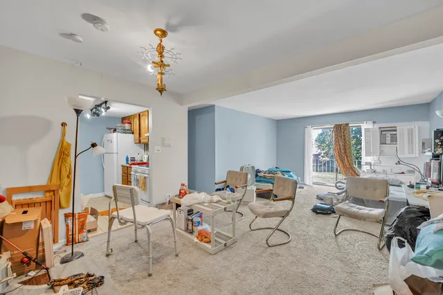 a living room with furniture and a chandelier