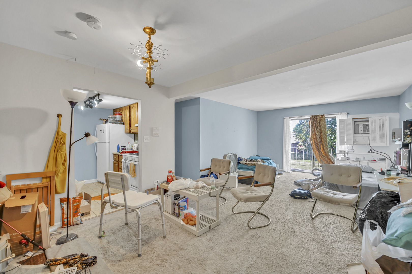 138 East Bailey Road, Unit M Naperville, IL 60565 - Photo 4 of 13 a living room with furniture and a chandelier