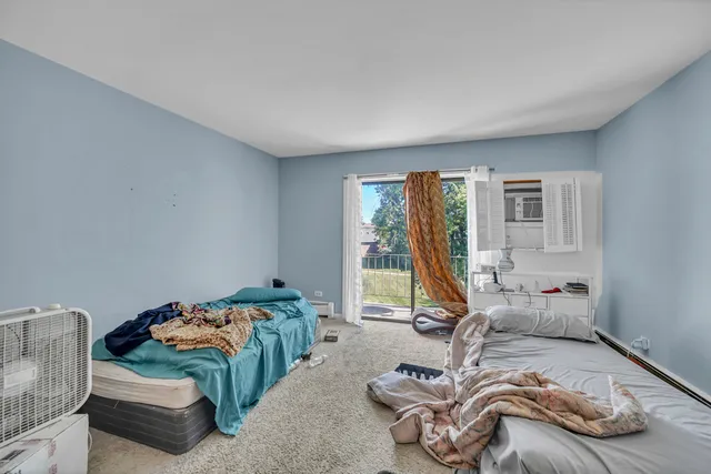 a bedroom with bed and a window