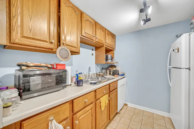 a kitchen with stainless steel appliances a refrigerator and a stove top oven