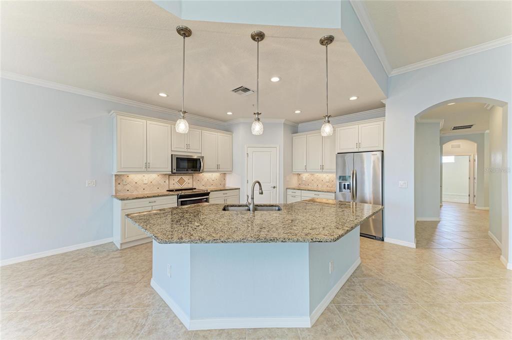 1246 Riverscape Street Bradenton, FL 34208 - Photo 14 of 68 a view of kitchen island a sink and a refrigerator