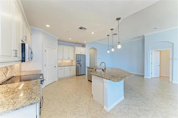 a kitchen with stainless steel appliances granite countertop a sink and a stove