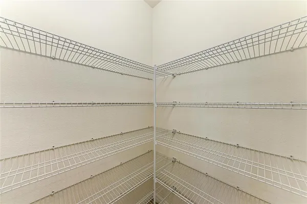 a open kitchen with white cabinets and a refrigerator