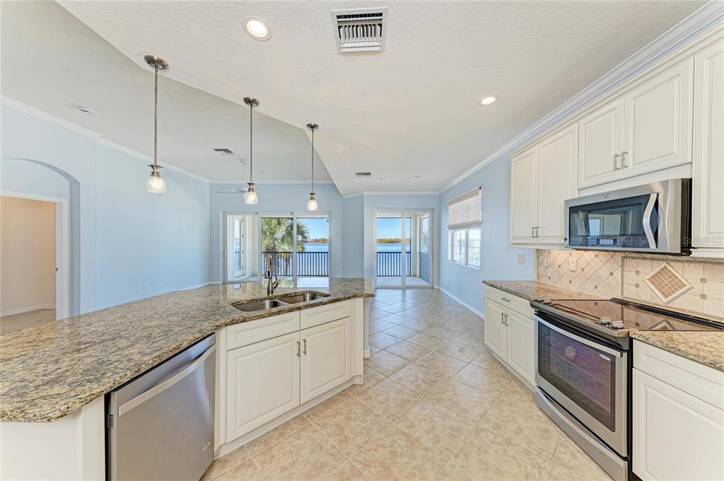 1246 Riverscape Street Bradenton, FL 34208 - Photo 19 of 68 a kitchen with stainless steel appliances granite countertop a sink and a stove