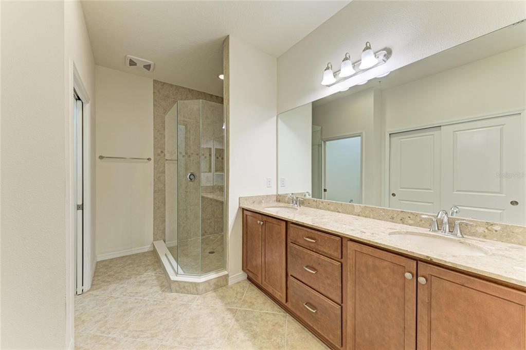 1246 Riverscape Street Bradenton, FL 34208 - Photo 33 of 68 a spacious bathroom with a shower sink double and mirror