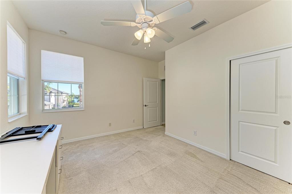 1246 Riverscape Street Bradenton, FL 34208 - Photo 39 of 68 an empty room with windows and fan