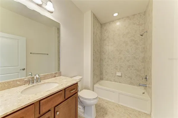 a front view of a house with a yard and potted plants