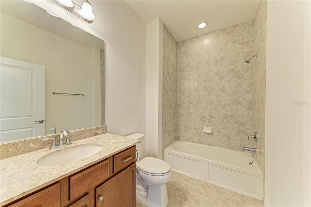 1246 Riverscape Street Bradenton, FL 34208 - Photo 40 of 68 a bathroom with a granite countertop sink toilet and shower