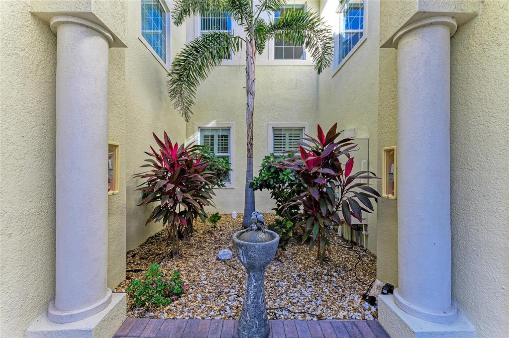 1246 Riverscape Street Bradenton, FL 34208 - Photo 7 of 68 a vase of flowers sitting on a table in front of a door