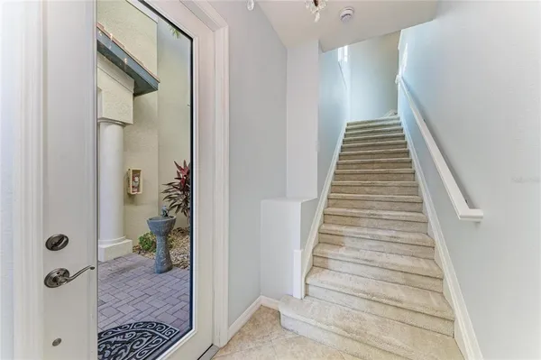 a view of a hallway with wooden floor and entryway