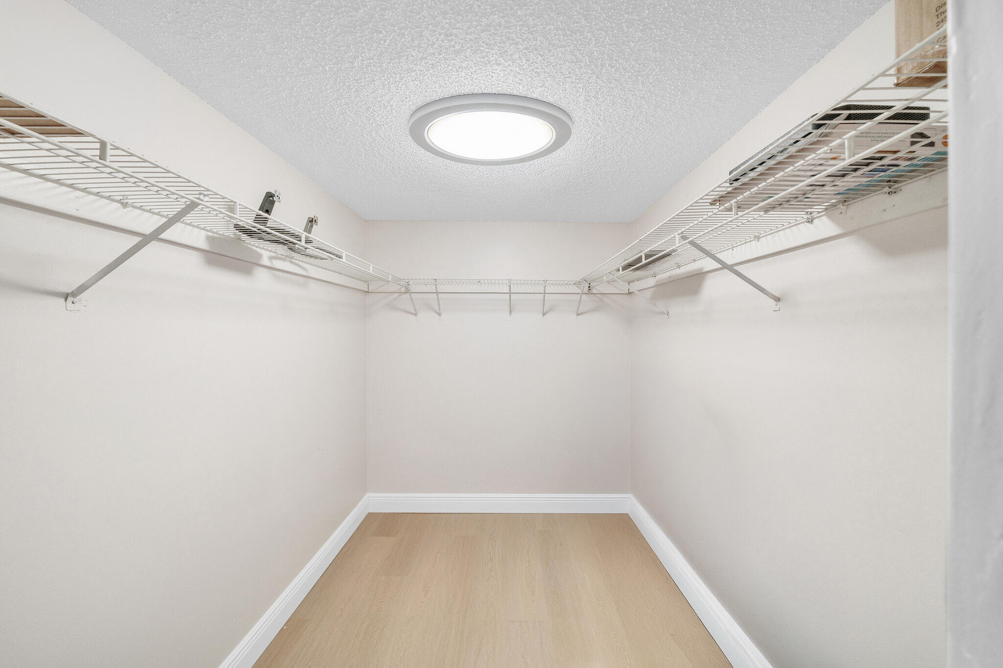 22136 Palms Way, Unit 103 Boca Raton, FL 33433 - Photo 26 of 42 a view of a room with racks on the wall