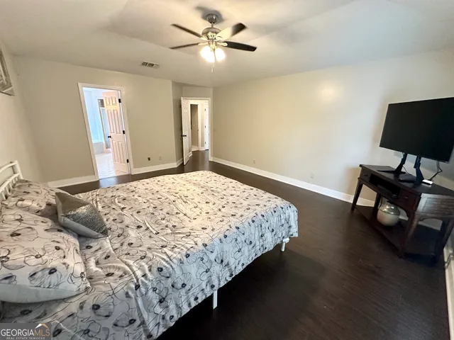 a bedroom with a bed and a potted plant