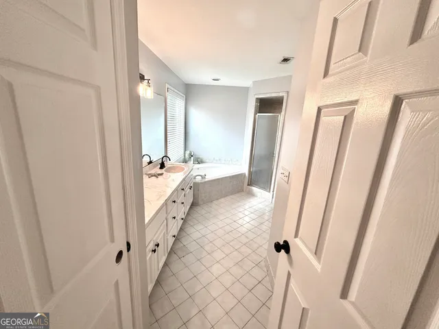 a bathroom with a double vanity sink and mirror