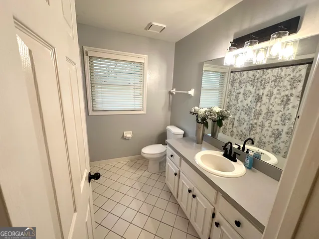 a bathroom with a shower and a toilet