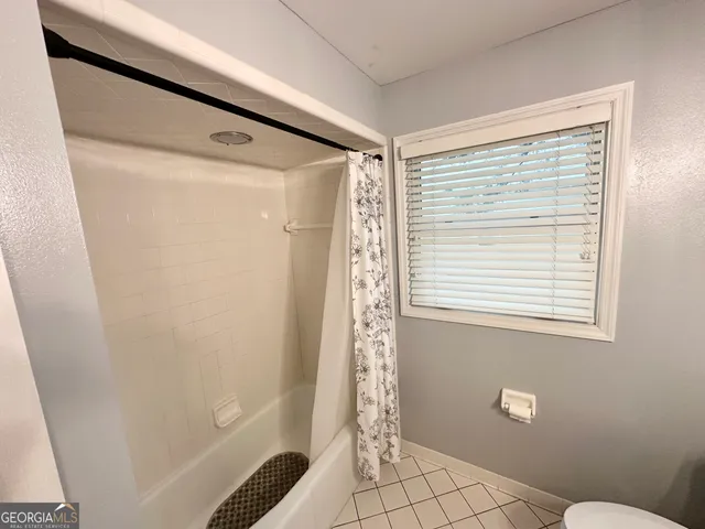 a bathroom with a double vanity sink toilet and mirror