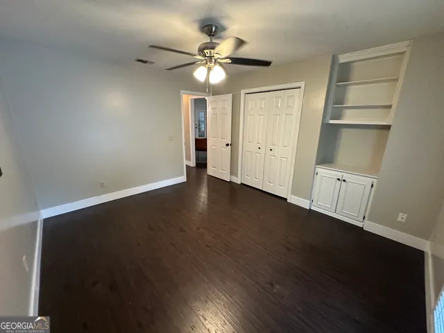 a view of workspace with furniture and floor to ceiling window