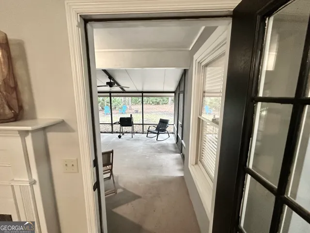a view of a room with gym equipment and floor to ceiling window