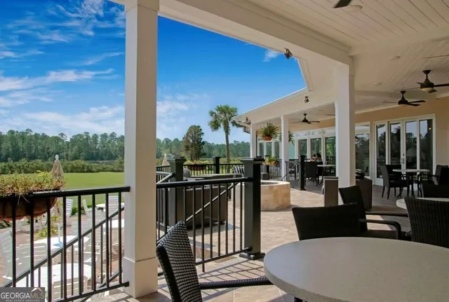 a view of a golf club with a backyard of the house