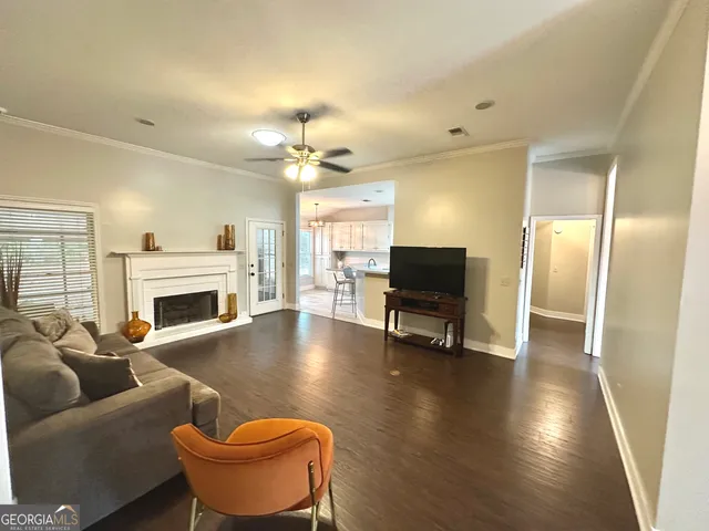 a living room with furniture a fireplace and a flat screen tv