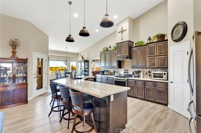 a living room with furniture a flat screen tv and a chandelier