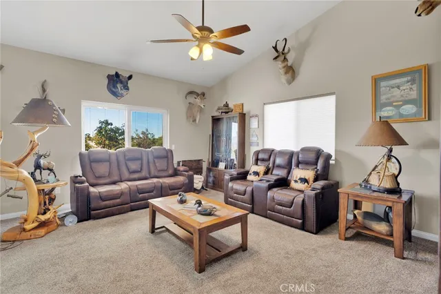 a living room with furniture a rug and a chandelier