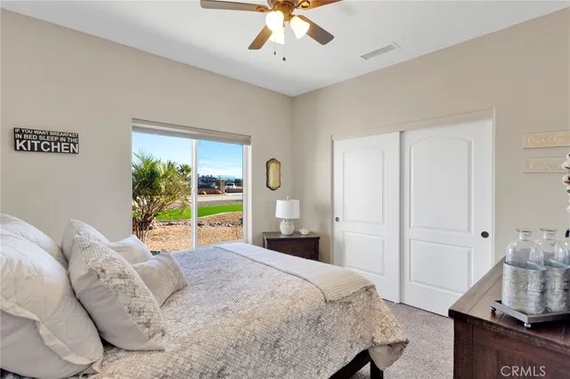 a bedroom with a large bed and a large mirror
