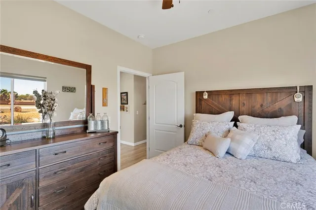 a bedroom with a large bed and a window