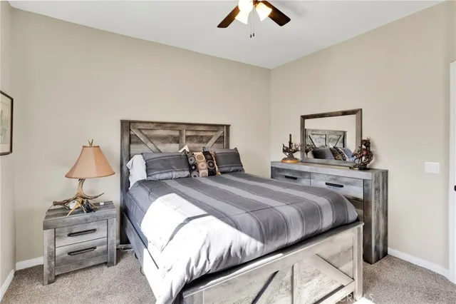 a bedroom with a large bed and a chandelier